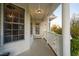 Charming front porch with white columns and railing, features a welcome sign and beautiful door at 2905 Glendale Rd, Kenly, NC 27542