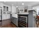Kitchen island with farmhouse sink, wine fridge, and gray cabinetry at 2905 Glendale Rd, Kenly, NC 27542