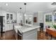 Bright kitchen with white cabinets, large island with sink, and stainless steel appliances at 2905 Glendale Rd, Kenly, NC 27542