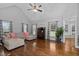 Spacious living room with hardwood floors, vaulted ceiling, and large sectional sofa at 2905 Glendale Rd, Kenly, NC 27542