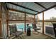 Cozy screened-in porch provides views of the pool, outbuildings and wooded area at 2905 Glendale Rd, Kenly, NC 27542