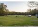 Wide open pasture featuring mature trees, fencing and an animal shelter, perfect for livestock at 2905 Glendale Rd, Kenly, NC 27542