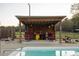 Outdoor pool area featuring a shelter with chairs and privacy at 2905 Glendale Rd, Kenly, NC 27542