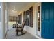 View of charming front porch with rocking chairs and a vibrant blue front door at 2905 Glendale Rd, Kenly, NC 27542