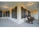Inviting front porch with rocking chairs and wooden shutters on windows at 2905 Glendale Rd, Kenly, NC 27542