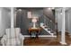 Cozy sitting area with hardwood floors, comfortable chair, and staircase at 2905 Glendale Rd, Kenly, NC 27542