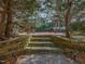 Stone steps lead through the backyard showcasing the natural beauty and landscaping at 2932 Candlehurst Ln, Raleigh, NC 27616