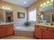 Primary bathroom featuring a jetted tub, dual vanities, and a separate shower at 2932 Candlehurst Ln, Raleigh, NC 27616