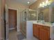 Bathroom with a glass enclosed shower, vanity with sink, and tiled floors at 2932 Candlehurst Ln, Raleigh, NC 27616