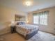 Cozy bedroom with large window, neutral carpet and charming decorative touches at 2932 Candlehurst Ln, Raleigh, NC 27616