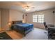 Comfortable bedroom with ceiling fan, desk, and large windows for natural light at 2932 Candlehurst Ln, Raleigh, NC 27616