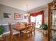 Formal dining room featuring hardwood floors, elegant lighting, and seating for six at 2932 Candlehurst Ln, Raleigh, NC 27616