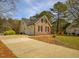 Beautiful home exterior featuring a two-car garage, brick accents, and well-maintained landscaping at 2932 Candlehurst Ln, Raleigh, NC 27616