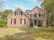 Inviting two-story brick home featuring classic shutters and a well-manicured lawn at 2932 Candlehurst Ln, Raleigh, NC 27616