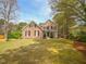 Charming home with a well-manicured lawn and mature trees creating a welcoming curb appeal at 2932 Candlehurst Ln, Raleigh, NC 27616