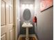 Stylish half-bath featuring a pedestal sink, oval mirror, and elegant lighting fixtures at 2932 Candlehurst Ln, Raleigh, NC 27616