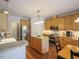 Modern kitchen with stainless steel appliances, wooden cabinets, and a central island at 2932 Candlehurst Ln, Raleigh, NC 27616