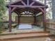 Charming outdoor pergola with seating, creating a cozy and inviting space for relaxation at 2932 Candlehurst Ln, Raleigh, NC 27616