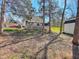 Backyard featuring a wooden deck with outdoor furniture, surrounded by trees and greenery at 30 Shannon Rd, Timberlake, NC 27583