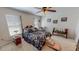 Bedroom with a patterned bedspread and bright natural lighting from the windows at 30 Shannon Rd, Timberlake, NC 27583