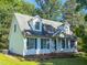 Charming home with white siding, dormer windows, and landscaped front yard at 30 Shannon Rd, Timberlake, NC 27583