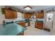Functional kitchen features wood cabinets, white appliances, and solid surface countertops at 30 Shannon Rd, Timberlake, NC 27583