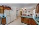 Bright eat-in kitchen features wood cabinets, laminate countertops, and white appliances at 30 Shannon Rd, Timberlake, NC 27583