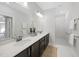 Modern bathroom featuring dual sinks, dark wood cabinets, and a luxurious walk-in shower at 301 Crayton Oak Dr, Cary, NC 27519