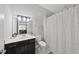 Clean bathroom featuring a vanity with sink, toilet, and shower with a decorative curtain at 301 Crayton Oak Dr, Cary, NC 27519