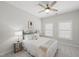 Well-lit bedroom with neutral walls, a ceiling fan, and two windows for natural light at 301 Crayton Oak Dr, Cary, NC 27519