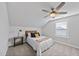 Comfortable bedroom with neutral walls, ceiling fan, and natural lighting at 301 Crayton Oak Dr, Cary, NC 27519