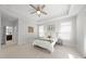 Bright bedroom features neutral paint, tray ceiling, and natural light from windows and doors at 301 Crayton Oak Dr, Cary, NC 27519