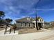 Community clubhouse exterior, featuring stone accents, bike racks, and landscaped grounds at 301 Crayton Oak Dr, Cary, NC 27519