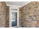 Close-up of the front door, featuring decorative stone siding and a classic lantern fixture at 301 Crayton Oak Dr, Cary, NC 27519