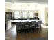 Bright eat-in kitchen with island, pendant lights, stainless appliances, and hardwood floors at 301 Crayton Oak Dr, Cary, NC 27519