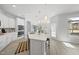 Well-lit kitchen featuring a spacious island, modern appliances, and stylish pendant lights at 301 Crayton Oak Dr, Cary, NC 27519