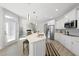 Bright, open kitchen featuring an island with a sink, stainless steel appliances, and a view of the living room at 301 Crayton Oak Dr, Cary, NC 27519