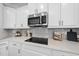 Contemporary kitchen with sleek countertops, stainless steel microwave and modern backsplash at 301 Crayton Oak Dr, Cary, NC 27519
