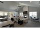 Open-concept living area features fireplace, ceiling fan, neutral paint and a kitchen area in the background at 301 Crayton Oak Dr, Cary, NC 27519