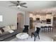 Open-concept living space with modern kitchen, ceiling fan, and stylish furniture at 301 Crayton Oak Dr, Cary, NC 27519