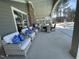 Outdoor patio offers comfortable wicker furniture, stone fireplace, and poolside lounging area at 301 Crayton Oak Dr, Cary, NC 27519