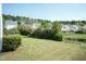 Large backyard with lawn, pond, and trees at 3011 September Dr, Durham, NC 27703
