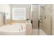 Luxurious bathroom featuring a soaking tub and glass-enclosed shower at 3011 September Dr, Durham, NC 27703