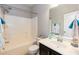 This bathroom features a shower-tub combo, vanity, sink, and neutral paint at 3011 September Dr, Durham, NC 27703