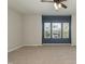 Spacious bedroom with carpet flooring, ceiling fan, and ample natural light from multiple windows at 3011 September Dr, Durham, NC 27703