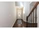 Bright foyer featuring hardwood floors, a staircase with iron railings, and a front door at 3011 September Dr, Durham, NC 27703