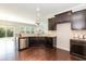 Well-appointed kitchen featuring dark cabinetry, granite countertops, and stainless steel appliances at 3011 September Dr, Durham, NC 27703