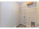 This laundry room has tile floors, wire shelving, and grey walls at 3011 September Dr, Durham, NC 27703