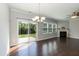 Bright and airy living room boasts hardwood floors, fireplace, large windows, and sliding door to patio at 3011 September Dr, Durham, NC 27703