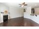 Open-concept living room featuring a fireplace, hardwood floors, and a view of the kitchen at 3011 September Dr, Durham, NC 27703